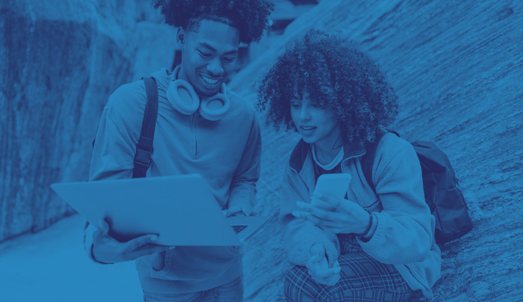 Two students looking at a laptop
