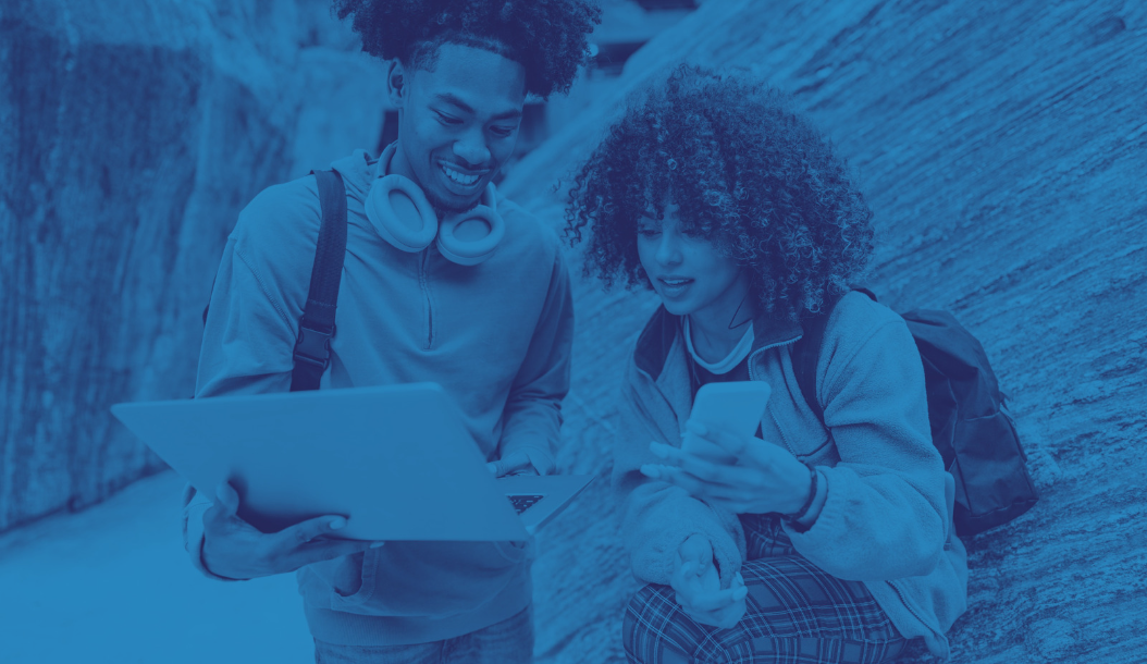 Two students looking at a laptop 